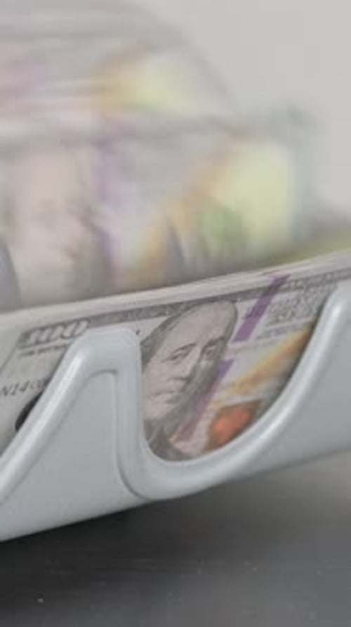Money Counter Machine Counting Stack of Hundred Dollar Bills