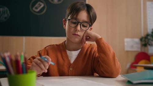 Caucasian Thoughtful Pensive Schoolboy at School Looking at Textbook Reading Book Education Study