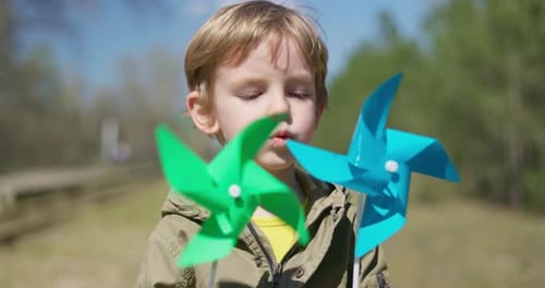Child Playing with Colorful Pinwheels Outdoors