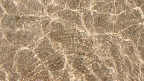Waves Rippling Gently on a Sandy Beach