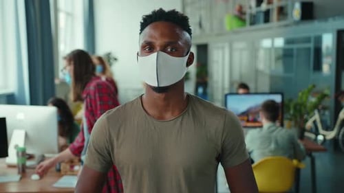 Young Adult Wearing Face Mask in Open Office