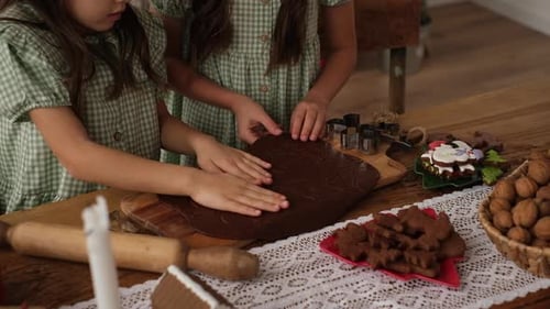 Two Girls Making Christmas Gingerbread Cookies at Home