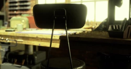 Workshop Chair Near a Workbench with Tools in Soft Morning Light