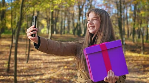 Attractive Lady Wearing Coat Walking in Park in Fall