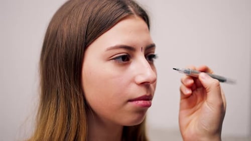 close-up plastic surgeon makes marks on a patient's face during a consultation before nose operation