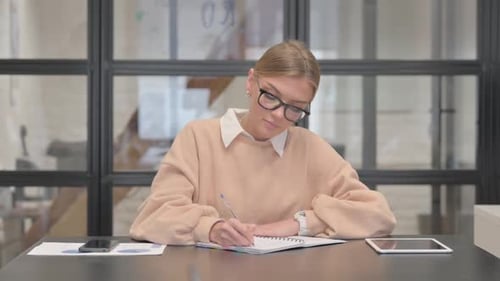 Young Woman Writing a Letter in Office