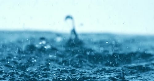 Rain water drops falling in super slow motion.