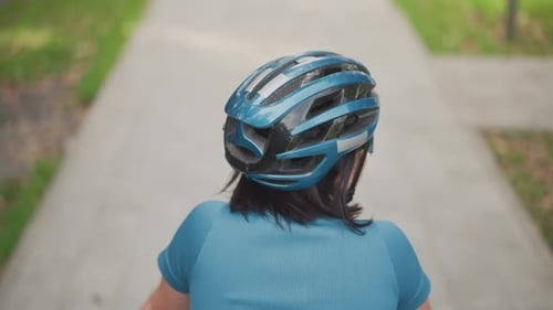 Calm Woman in Sweater Riding Bicycle Through Peaceful Neighborhood Scenery Solitary Female Cyclist