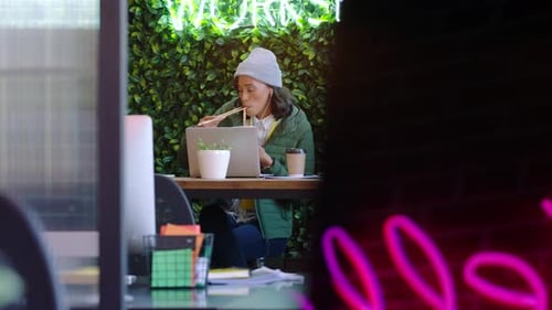 Video call, laptop and lunch, woman in cafe or coffee shop eating and freelance online meeting