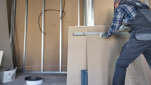 Contractor Constructing Interior Drywall Segments