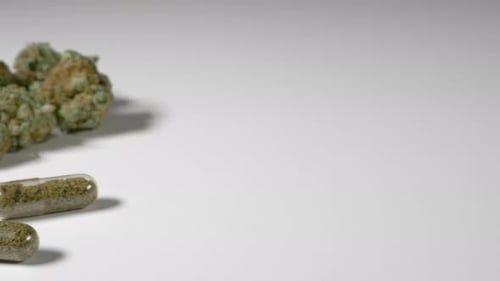 Cannabis Buds and Filled Capsules Close Up