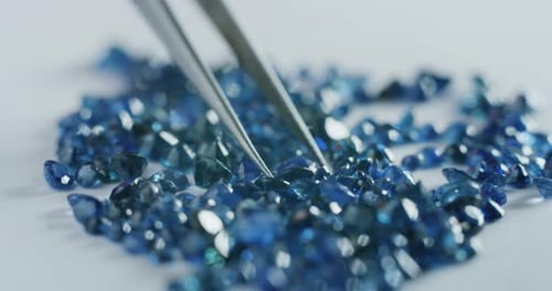 Brilliant Blue Gemstones Displayed with Precision Tweezers