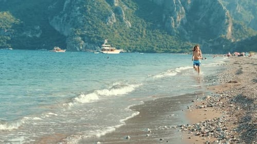 Happy Friends Running Together on Sea Beach at Summer Vacations. Siblings Running