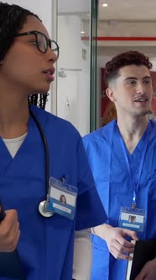 Diverse team of medical students walking through hospital hallway