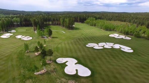 Aerial View of a Stunning Golf Course with Sand Traps and Lush Greenery Creating Beauty