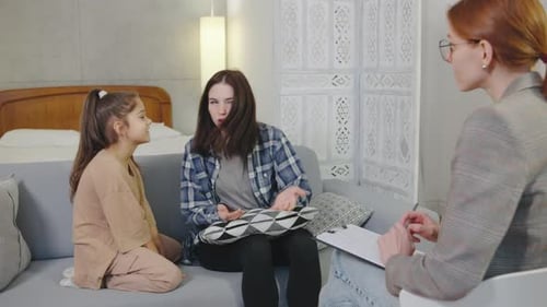 Mother and Daughter in Therapy Session on Couch