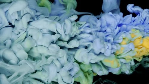 Colorful Ink and Paint Mix Generating Cloud Patterns in Abstract Motion
