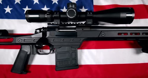 Modern Sniper Rifle on American Flag Background