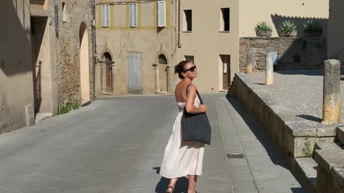 Woman Walking Down a Picturesque Italian Street