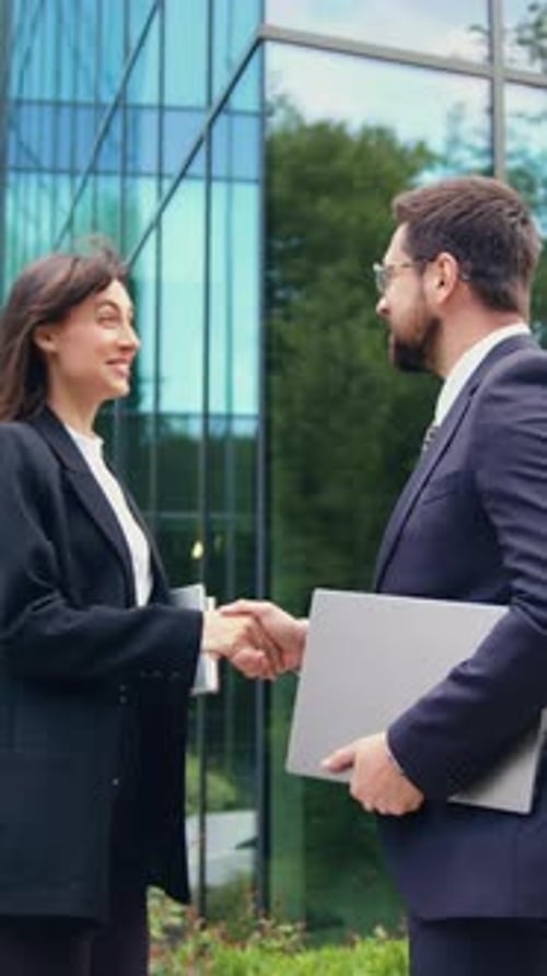 Business Meeting: Woman and Man Shake Hands Outdoors
