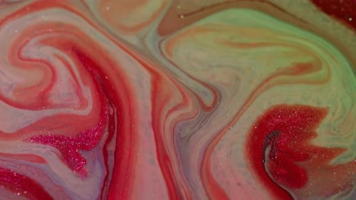 Swirling red white green abstract paint mix