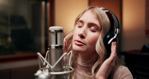 Woman, musician and singing in music studio for song recording with microphone for voice control