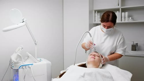 Woman Receiving Facial Treatment in Medical Setting