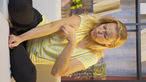 Vertical video of Woman with itchy arms.