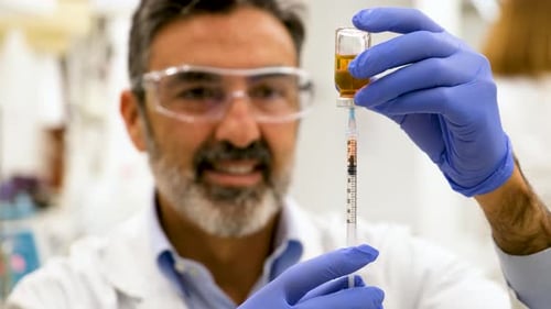Scientist Using Syringe in Lab Close Up