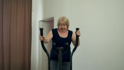 Woman Doing Elliptical Exercise at Home