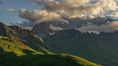 Dramatic Clouds over Mountain Peaks at Sunset