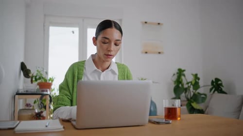 Woman Working on Laptop in Bright Home Office