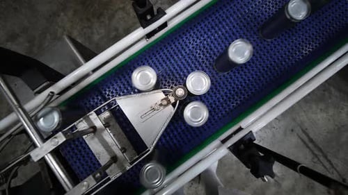 Food canned factory. Food tin cans on belt conveyor. Food industry.