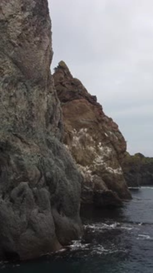 Aerial View on Calm Azure Sea and Volcanic Rocky Shores Small Waves on Water Surface Nature Summer