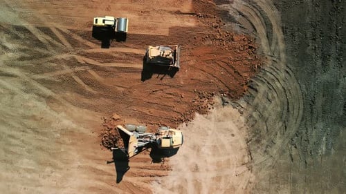 Aerial Above Shot of Excavator Loads Sand Into Mining Truck