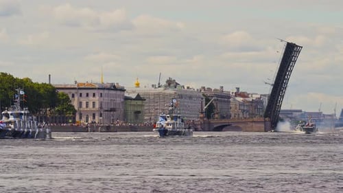 A Lot of Warships Goes Along the Neva River Under Open Bridges at the Time of the Rehearsal of the