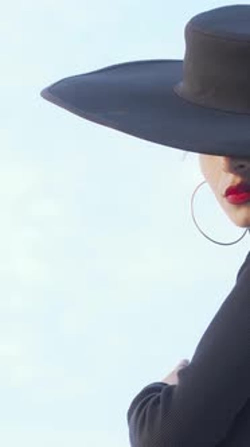 Fashionable Woman Posing Outdoors With Wide Brim Hat
