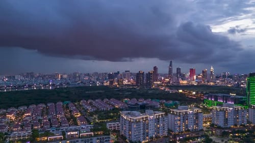 Aerial Evening hyperlapse of Ho Chi Minh City Skyline and approaching storm.