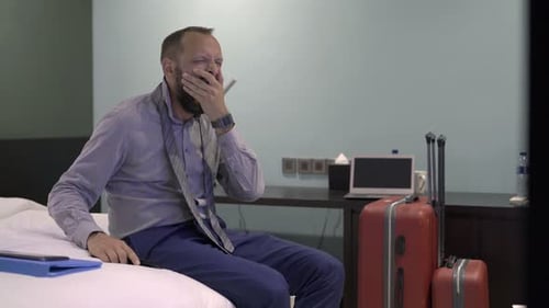 Tired Businessman Napping in Hotel Room