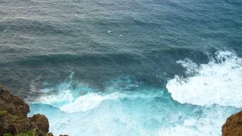 Big waves on a coastline ocean top shot with rock in madeira