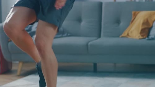 Slow Motion Close Up of a Strong Athletic Fit Man in T-shirt and Shorts is Energetically Jogging in