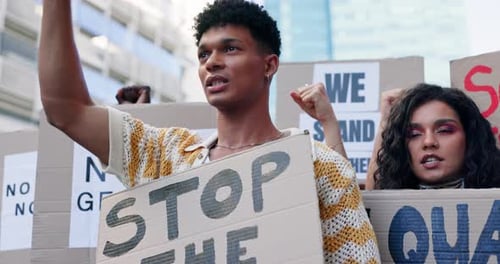 Young Adults at Protest Holding Signs