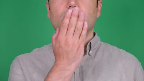 Person Covering Their Mouth on Green Screen
