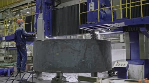 Worker with Automated Grinding at Factory Stock Clip Worker with Remote Control of Automated Machine