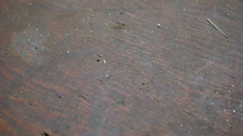 Screws falling onto a workbench, slow motion footage