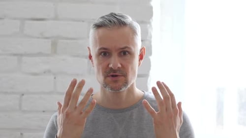 Frustrated Angry Middle Aged Man Yelling Sitting in Office