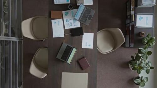 Top View of Desk with Laptops and Presentation Pages in Corporate Office