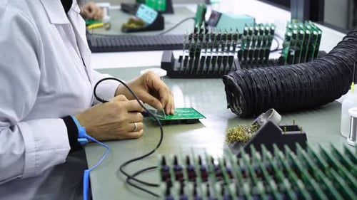 Women Soldering On The Microchips In The Factory