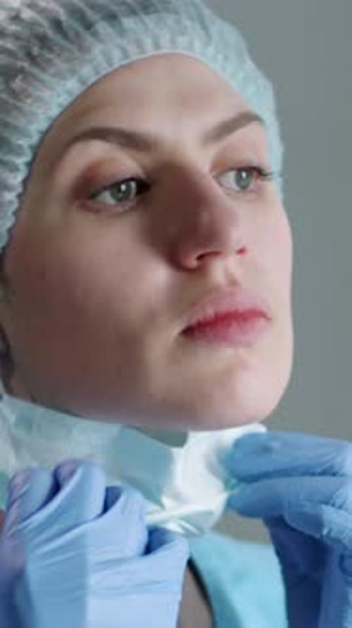 Portrait of Tired Nurse Removing Surgical Mask and Posing for Camera in Hospital