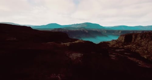 Majestic Mountain Landscape Under Soft Clouds and Blue Skies at Daytime